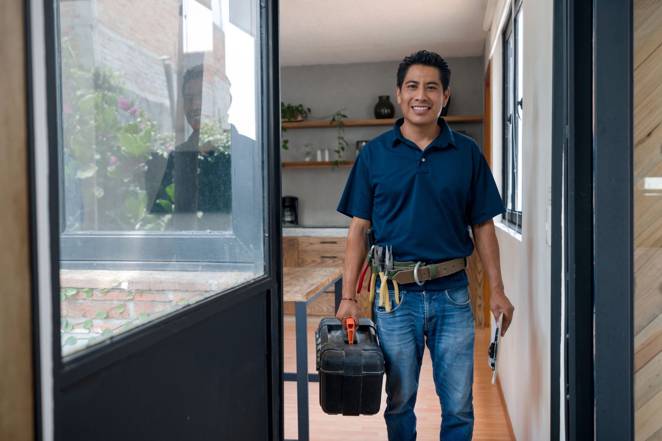 Handyman fixing plumbing under a sink